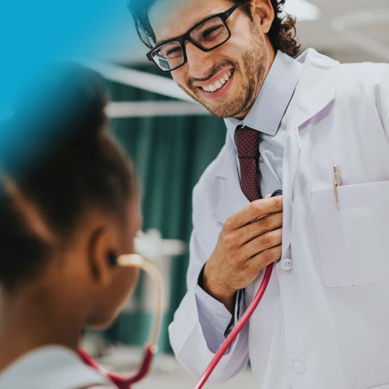 A photo of a child using a stethoscope on a doctor